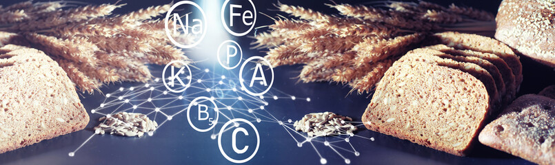Fresh loaves of bread with wheat and gluten on a black table. Bakery and grocery concept. Fresh, healthy sorts of rye and white loaves food closeup. Fresh homemade bread with cereals.