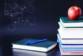 A stack of textbooks and books on the table. The concept of knowledge.