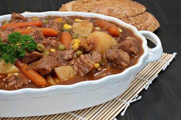A dish of hearty vegetable beef stew. Macro and partial view.