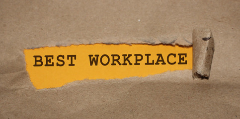 Best Workplace words appearing under brown torn paper. HR human resources management in successfull...