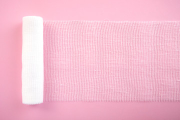 White sterile bandag or gauze on a pink background.