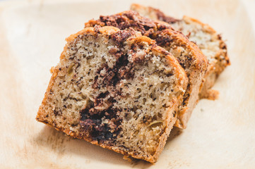 Banana Nutella Chocolate Cake on wooden plate- top view