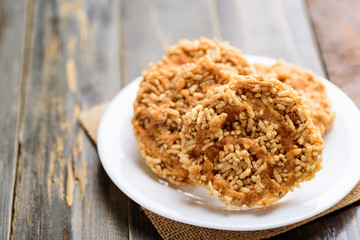 Sweet crispy rice mixed with watermelon juice with cane sugar drizzle, Local Thai snack (Khao Tan Nam Tangmo)