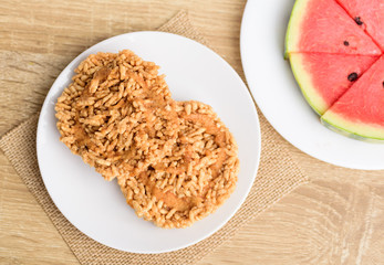 Sweet crispy rice mixed with watermelon juice with cane sugar drizzle, Local Thai snack (Khao Tan Nam Tangmo), Top view