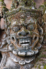 Fototapeta premium Traditional stone statue in Balinese landscape in soft focus