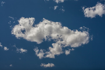 White cumulus clouds in the blue sky