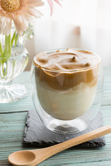Whipped dalgona coffee on a wood background - ダルゴナコーヒー