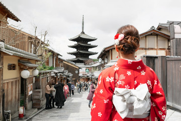 Asian woman wearing traditional Japanese kimono walking in the old town of Kyoto, Japan