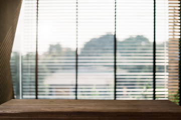 Empty space on wooden table at window in the morning light bokeh.	