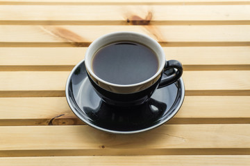 Cappuccino in a cup on a wooden background, product photography