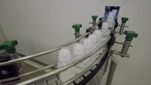 plastic bottles on Medical Solutions Conveyor . Blow fill seal technology technique used to produce liquid-filled container on medical or food industrial factory. medical industry