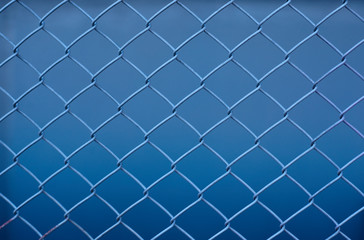 Fototapeta na wymiar metal mesh on a blue background, abstraction, woven metal mesh pattern