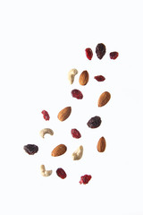 pouring nut mix against white background. Concept of flying food