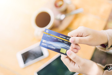 Young woman paying for cafe by credit card