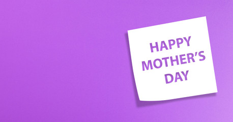 Note paper with happy mother's day message on purple background