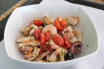 Fish salad with tomatoes and olives