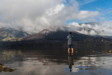 A photographer taking picture of Rinjani active volcano mountain, Lombok island in Indonesia
