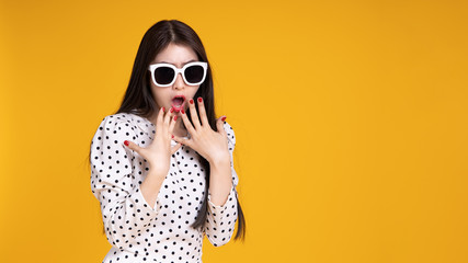 Fototapeta premium Asian woman in summer casual clothes.She smiling and happy shopping. she lovely attractive shine on yellow background.Summer Surprise Sale concept.