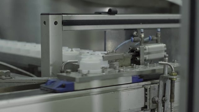plastic bottles on Medical Solutions Conveyor . Blow fill seal technology technique used to produce liquid-filled container on medical or food industrial factory. medical industry