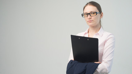 Happy beautiful woman in glasses business with a clipboard