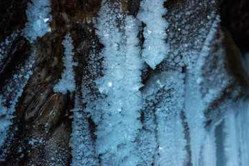 Blue crystal ice grotto cave with icicles, broken ice and snow. Winter landscape. 