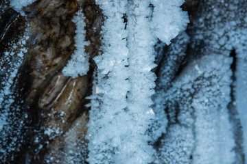 Blue crystal ice grotto cave with icicles, broken ice and snow. Winter landscape. 
