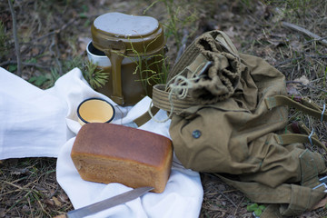 bread and military flask on a white towel