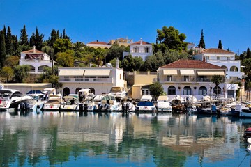 Scenic in the old harbor of Spetses island, Greece, with fishing boats and beautiful mansions,...