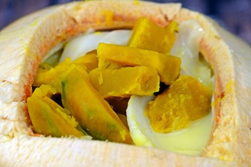 Pumpkin in sweet coconut milk served in coconut, Authentic Thai dessert.