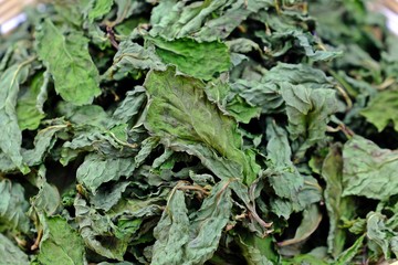 Close up dried organic peppermint leaves for herbal drink tea.