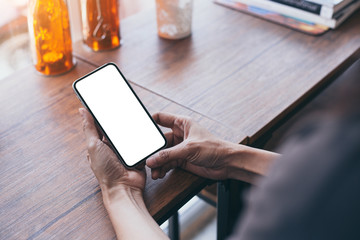 cell phone Mockup image blank white screen.woman hand holding texting using mobile on desk at coffee shop.background empty space for advertise.work people contact marketing business,technology