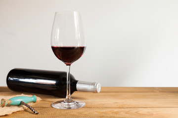 Red wine bottle lying down and red wine glass