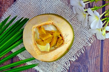 Pumpkin in sweet coconut milk served in coconut, Authentic Thai dessert.