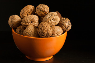  Orange color bowl with walnuts