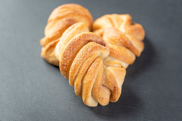 sweet, homemade brioche with cinnamon on dark background