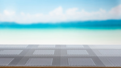 empty of table cloth on top in front of the white beach, background for plain text or products