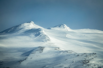 Fototapeta na wymiar Winter landscape with dramatic snowy mountains.