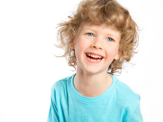 Portrait of a happy child. A curly-haired European boy on a white background laughs merrily. Violent emotions, celebration. A dream come true.