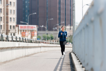 A young Asian Chinese woman is running