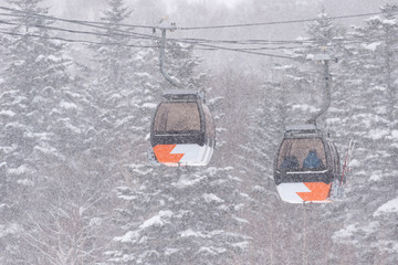 Orange ski lifts in the snow in japan