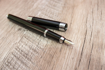 black pen on a wooden background.
