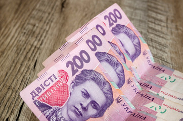 200 hryvnia on a wooden background. Close-up.
