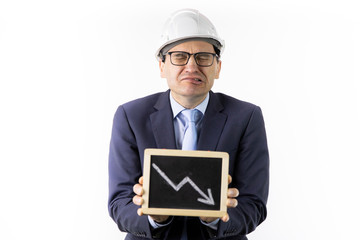 Crying mining engineer in hard hat holds tablet with down arrow declining oil quotes. Oil refinery industry, stock drop, quotes reduction, collapse of oil market, reduction in oil production concept