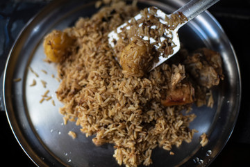 Homemade chicken Biryani is being served in a steel plate. Indian homemade food
