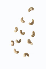 pouring cashew against white background. Concept of flying food