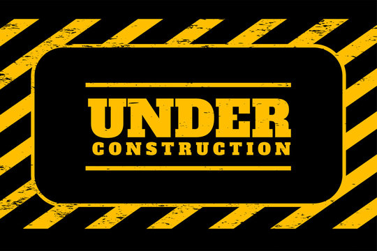 under construction background in yellow and black stripes