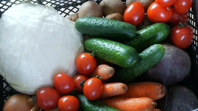 Box with vegetables potatoes beets cucumbers cherry tomatoes cabbage onions carrot close up. Food delivery services during coronavirus pandemic and social distancing. Shopping online. Food Donations.