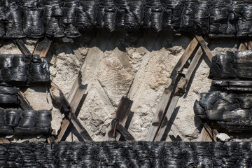 Background from a wall and a frame from black burnt wood.