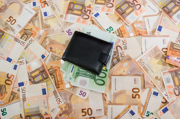 black men's wallet on euro banknotes. Much money.