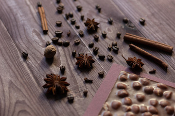 Obraz na płótnie Canvas Spices, coffee beans, chocolate on brown wooden background